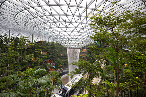 Singapore - January 7, 2024: Singapore Jewel Changi Airport. Singapore Airport Monorail Train driving through the huge Jewel Changi. The Singapore Jewel Rain Vortex is the largest indoor waterfall in the world located inside the Jewel Changi Airport in Singapore. Singapore Airport Monorail Train driving through the huge Jewel Changi.