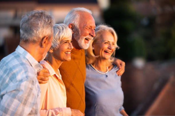 istock Cheerful senior friends walking embraced in nature. 2047277033