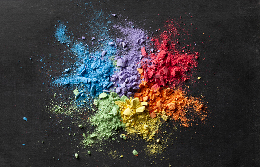 Multicolored chalk powder on a chalkboard.