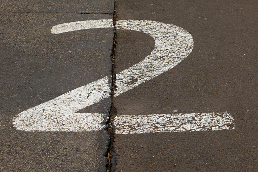 a street on a road with the number two painted on it