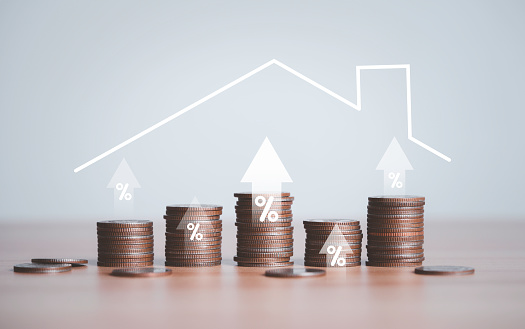 Coins stacking with up arrow percentage and house roof for home loan and real estate debt increasing concept.