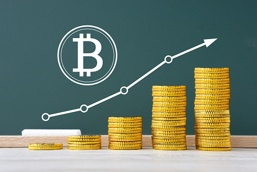 Piled coins and Bitcoin with upward arrow