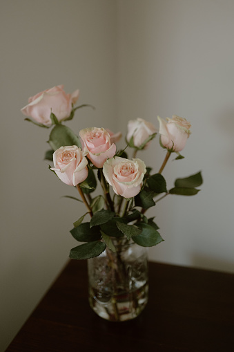 The subtle sophistication meets natural charm in the gentle hues of pink roses, a serene centerpiece for any setting