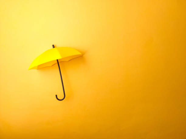 istock Top view yellow umbrella on a yellow background 2047382543
