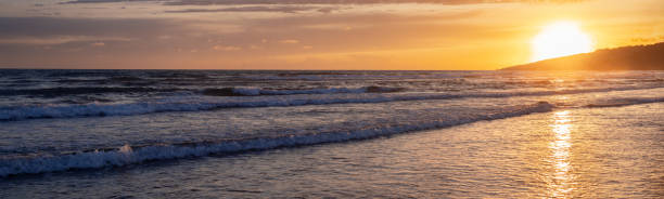 istock the banner. A series of low rolling waves runs over the sandy beach. A sunny path 2047415746