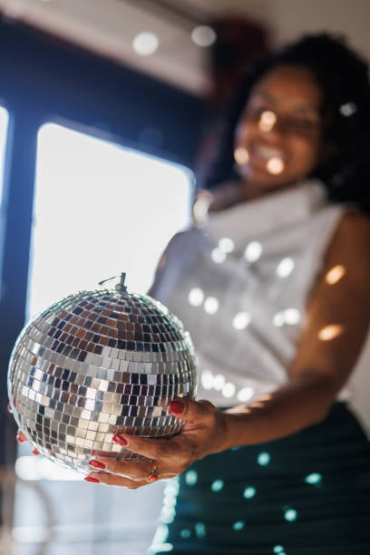 istock Charming woman holding a disco ball 2047417796