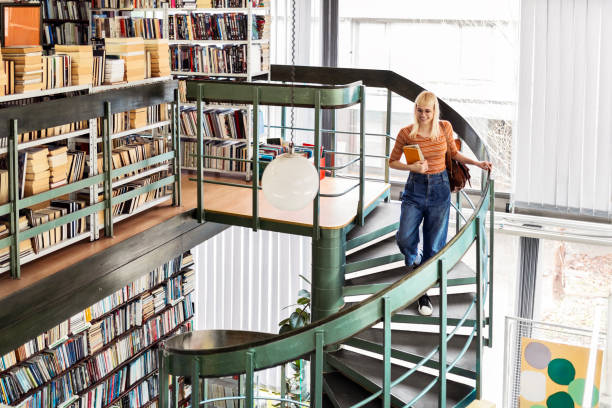 Library search, geek student or intelligent man for phd research, creative vision and knowledge in university. College, stairs above and person thinking of books for education, scholarship or study