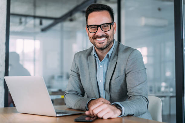 istock Successful businessman in modern office working on laptop. 2047432577