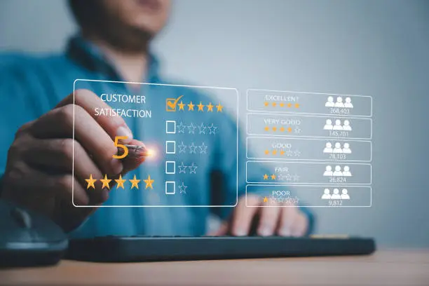 Photo of Client use pen to tick select excellent five stars rating on virtual screen for customer online evaluation after use product and service concept.