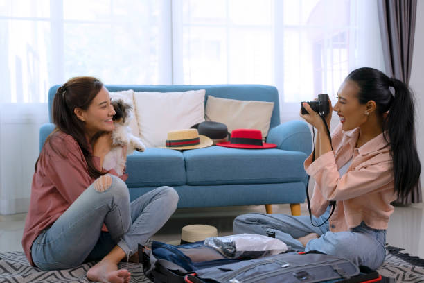 istock Pretty women prepare suitcase for travel. 2047443751