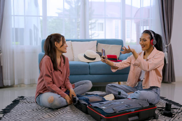 istock Pretty women prepare suitcase for travel. 2047443990