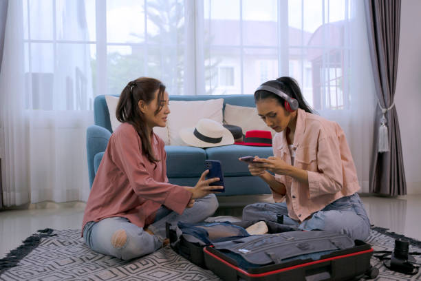 istock Pretty women prepare suitcase for travel. 2047444281