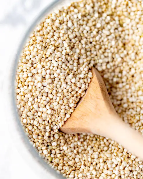 Organic White Quinoa in a Glass Container. Healthy Eating Concept.