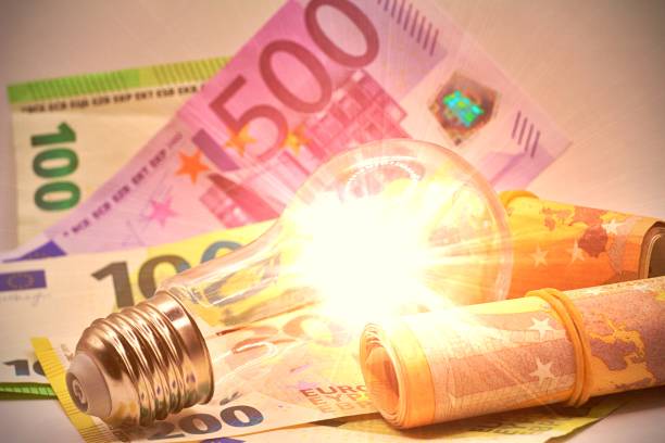 istock Light bulb turned on, with Euro banknotes around. Increase in electricity tariffs, energy dependence, energy sources and energy supplies. 2047454723