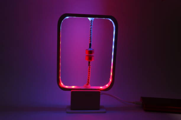 Modern desk lamp emitting rgb colors. Gradient light illuminated from a modern desk lamp with colorful background