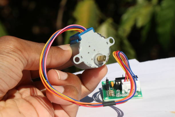 istock Stepper motor used in various hobby electronics projects held in the hand with stepper motor driver on the background 2047463797