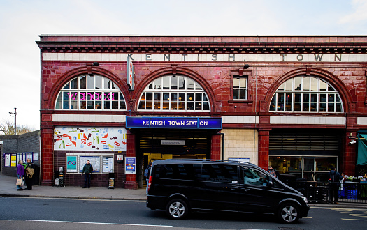 London, UK - June 11, 2014: Public call police box with mounted a modern surveillance camera near Earl's Court tube station in London.