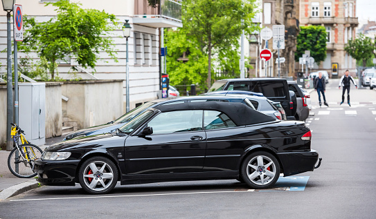 Strasbourg, France - May 20, 2021: Side view of black luxury vintage Saab 93e cabrio car parked on French street