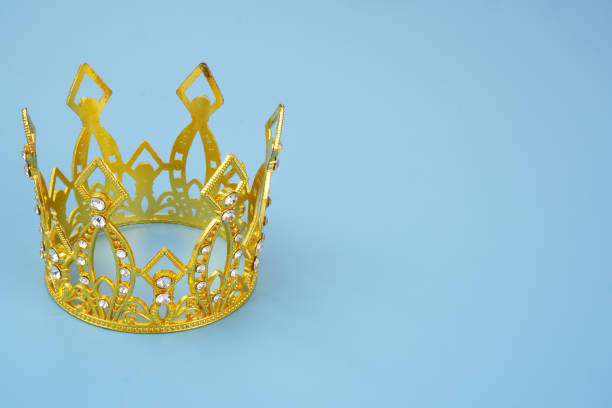 istock Gold crown with diamonds on blue background. 2047499535