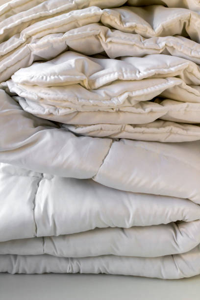 istock White color, folded clean double quilt on white surface 2047502206