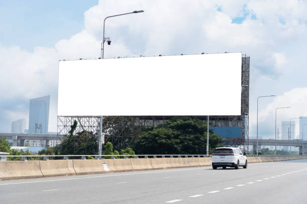 istock Blank billboard advertising erected outside against a cityscape,copy space for text. Large horizontal blank sign on a highway in Bangkok. 2047503811