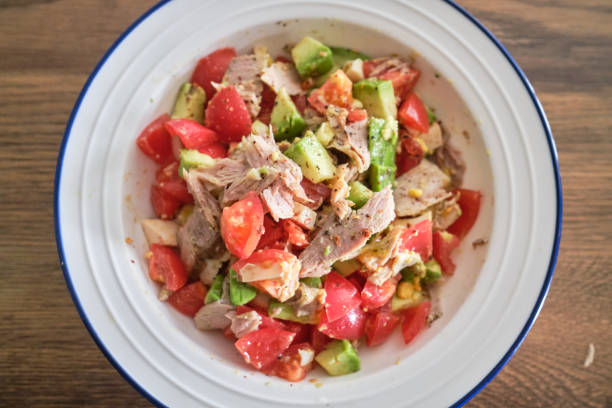 healthy salad made with avocado, tomato and tuna