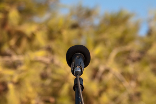 Microphone standing for speaker on the outdoor natural setting for music, concert and environmental awareness talk with copy space