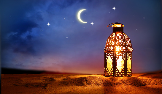 Colorful Ramadan lantern on desert dunes. Islamic greeting Eid Mubarak cards for Muslim Holidays. Crescent moon and stars.