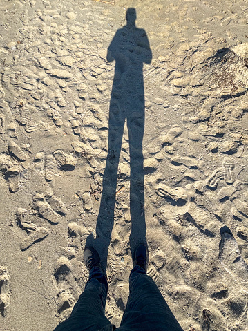 standing man on the beach sand stock photo