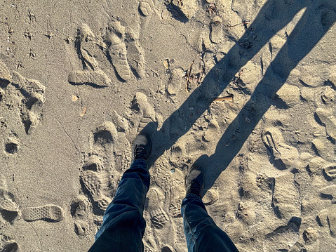 standing man on the beach sand stock photo