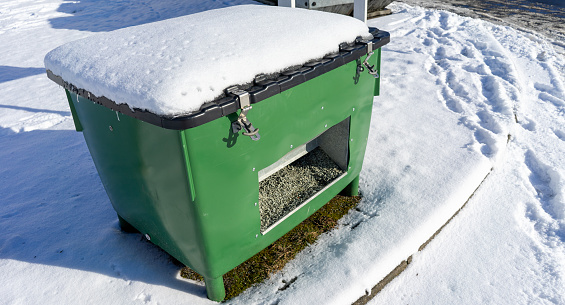 Containers with grit on the side of the road in winter service