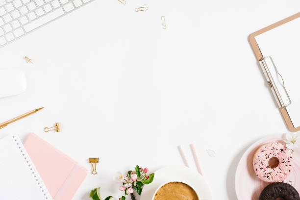istock Flat lay home office workspace female blogger background with white modern keyboard, notebook, cup of coffee, donut and apple flowers, copy space on white background 2047533279