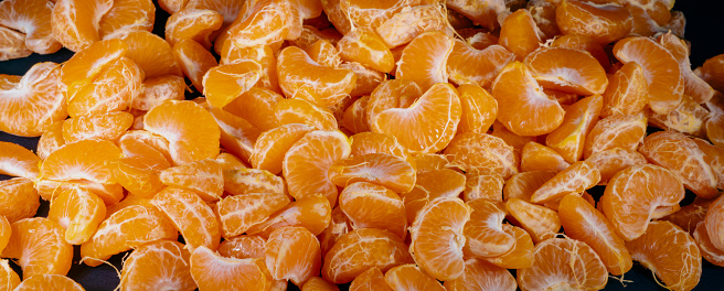 A ripe orange is peeled