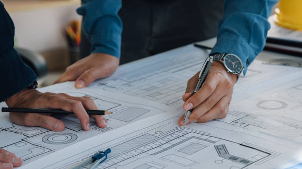 istock Engineer teams working together in the office. Engineer, Architect, Industry and factory concept. Blueprint, Helmets hardhat, Industry Architect, professional team and factory. 2047556644