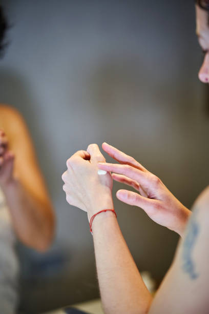 istock A close up of a woman's hand with moisturizer cream on it. 2047579450