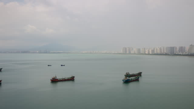 day time sanya city bay cargo ship parking rooftop panorama 4k timelapse hainan island china