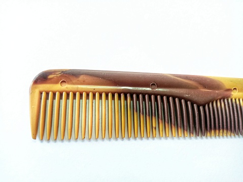 Yellow and brown hair comb