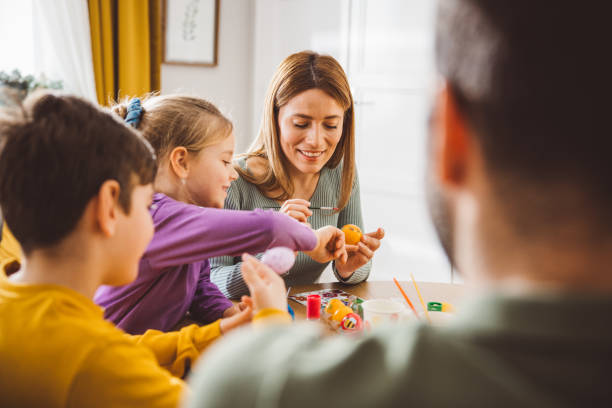 istock Happy family preparing Easter at home 2047618228