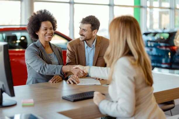 istock Couple Shaking Hands With Female Sales Agent 2047621494