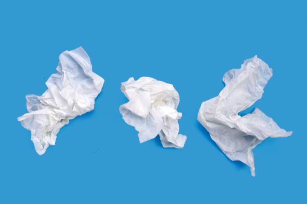 istock Crumpled tissue paper. Facial tissue on blue background. 2047628579
