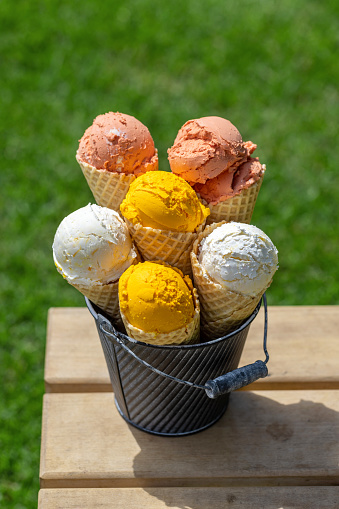 Assorted ice cream flavours in delightful waffle cones, a treat for every taste bud. Outdoor