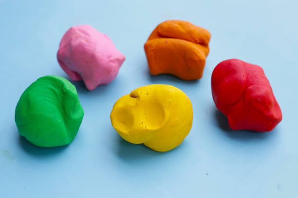 istock Colorful plasticine clay on blue background. 2047675419