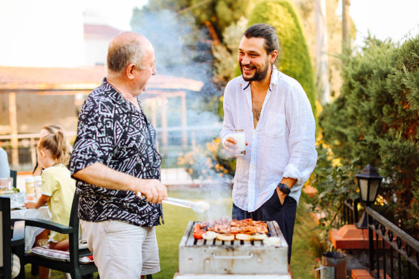 istock Mid adult man preparing barbecue with his dad 2047696298