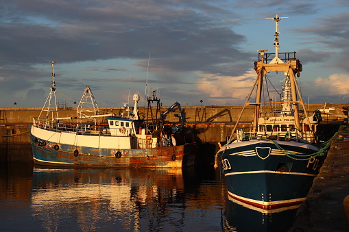 Close up of fishing boats moored in Fraserburgh harbour, Aberdeenshire, Scotland at dusk