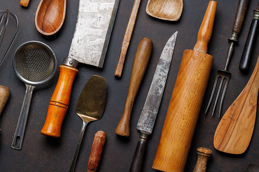 Culinary essentials: Diverse cooking utensils on stone table. Flat lay