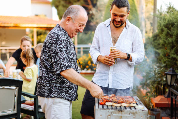istock Mid adult man preparing barbecue with his dad 2047698958