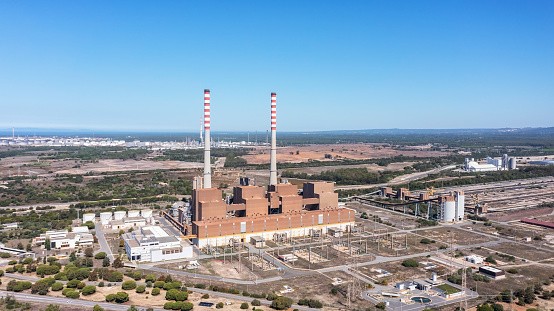 Aerial view of a coal-fired power plant in the city of Sines, overlooking the sea in Portugal. High quality 4k footage. Industrial area of the city.