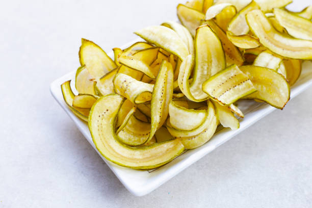 istock Banana chips, fried slices banana with green peel 2047712888