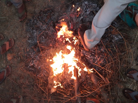 Wooden fire. People of village heating fire in cold evening. In the rural area, many people were on fire on a cold night.