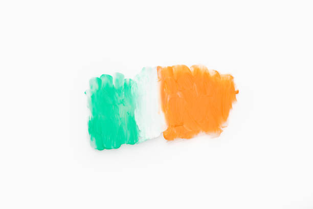 Green white and orange color paint splotches on white background. Irish flag design element for creative art and craft use